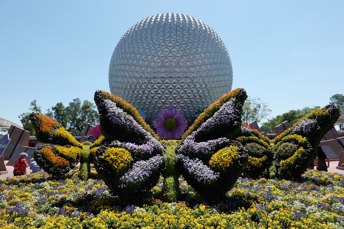 Spaceship Earth at Epcot behind a butterfly topiary during the Flower and Garden Festival